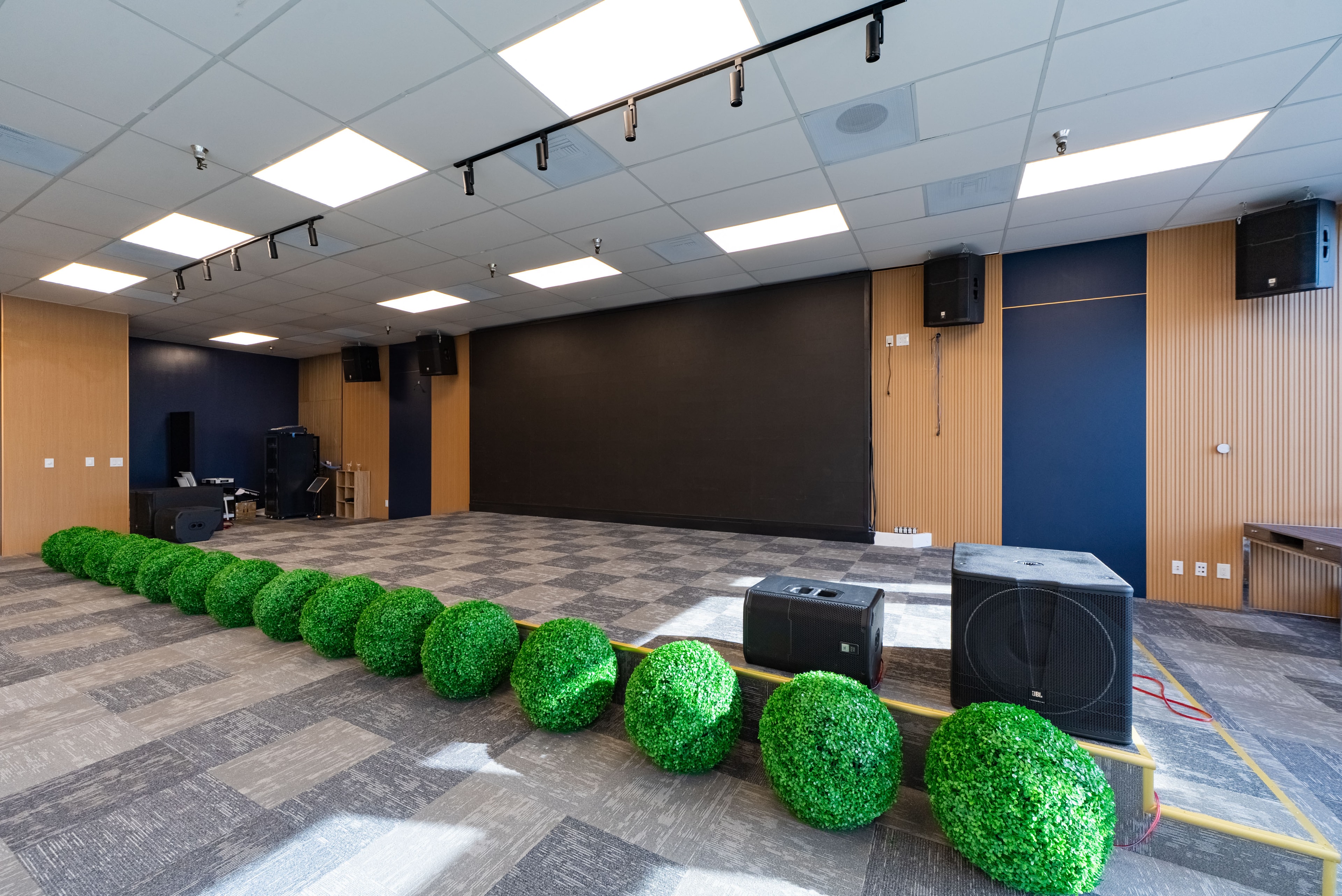 Sola Pavilion main hall — open floor plan with LED screen and JBL speakers