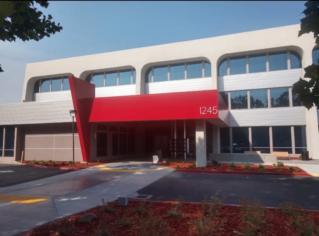 Close-up of the striking red entrance canopy and building number 1245 at Sola Pavilion