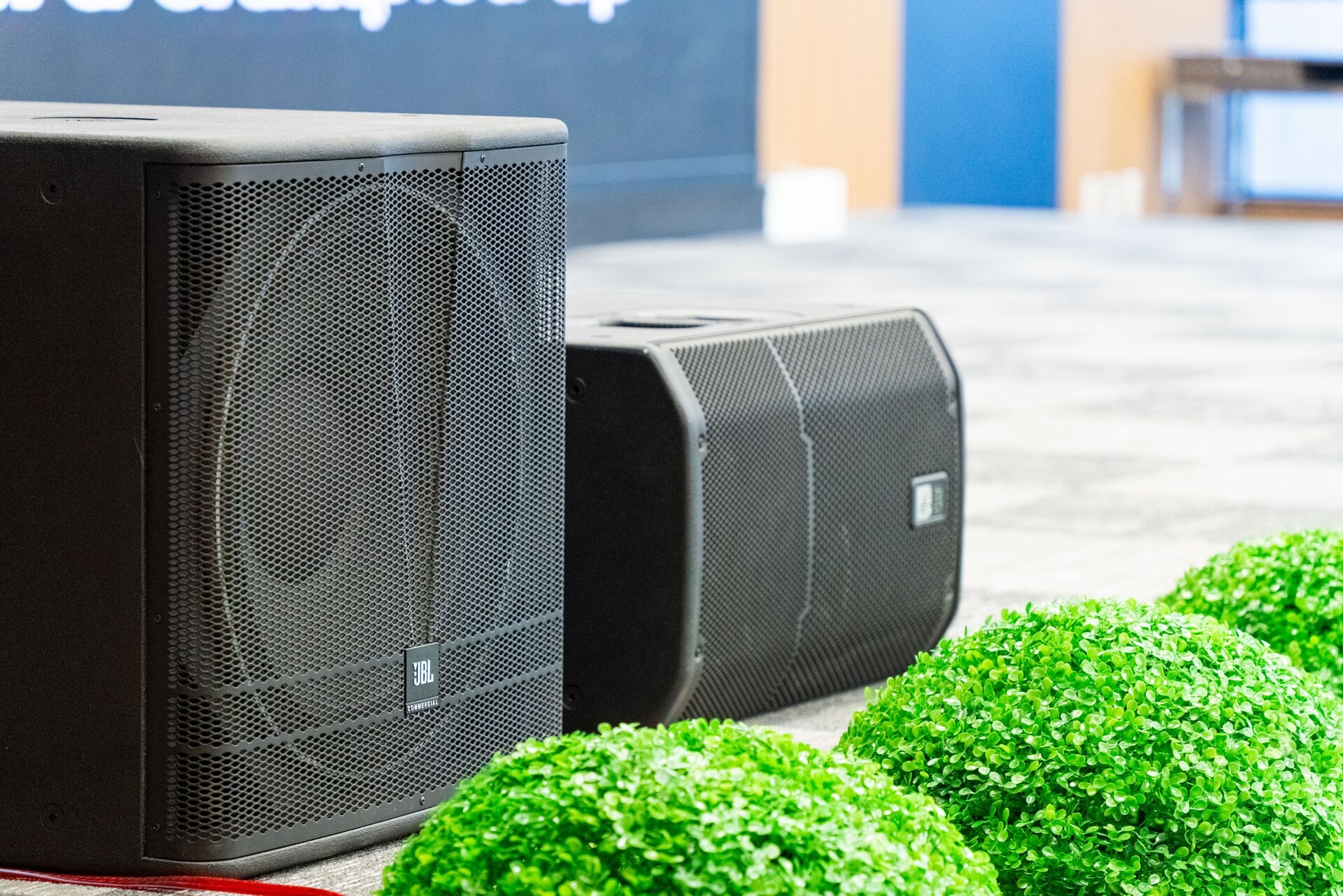 JBL commercial surround sound speakers on the venue floor