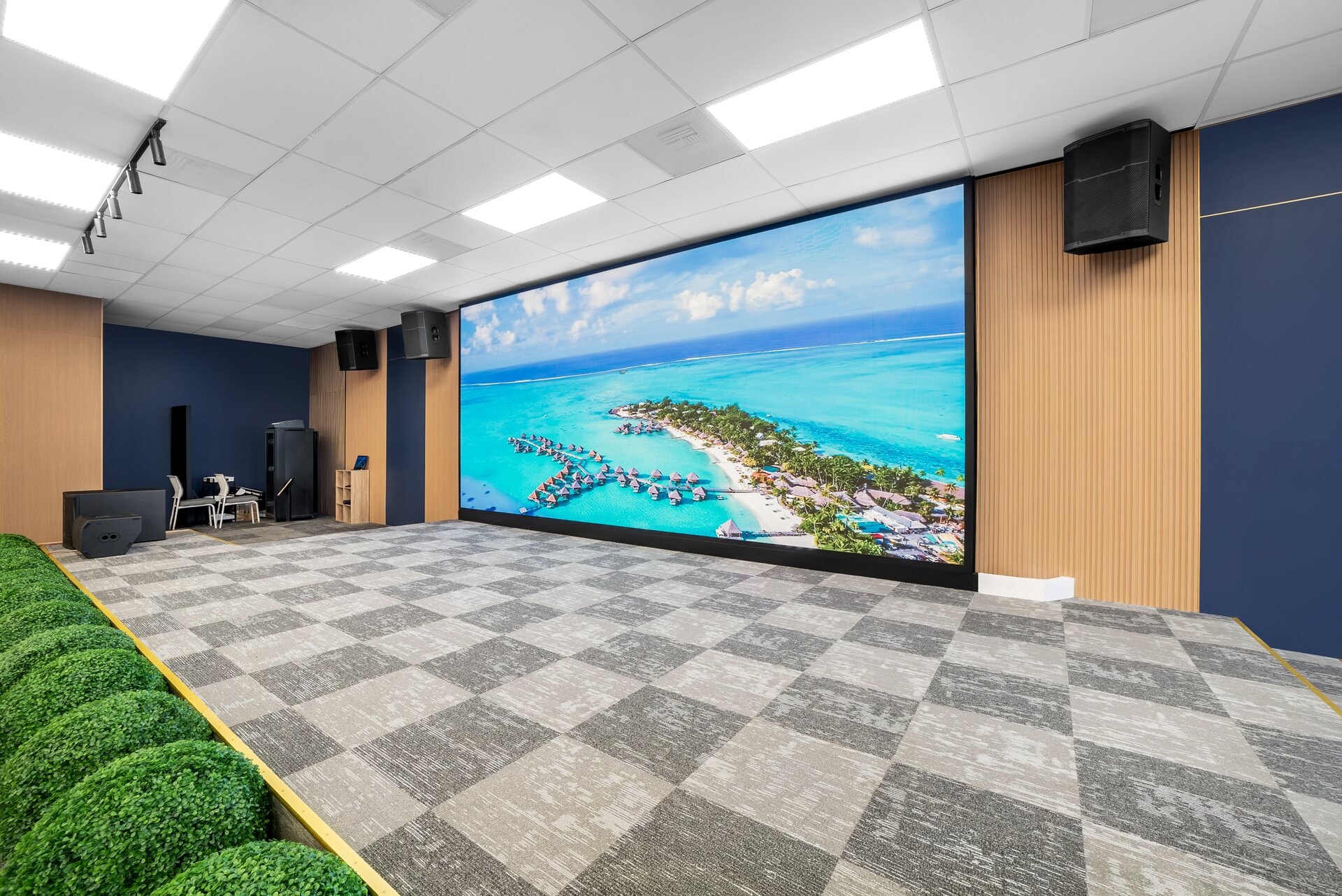 Floor-to-ceiling LED display showing a tropical scene in the main event hall