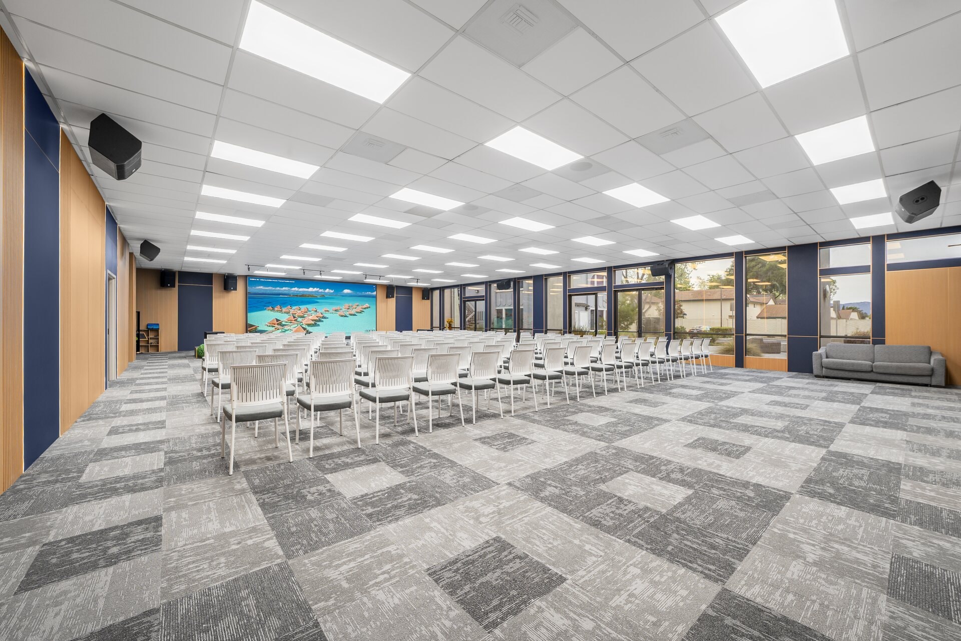 Sola Pavilion main hall configured with rows of modern white chairs for a conference